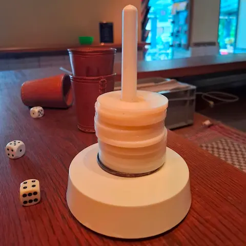 Three dice lying on a wooden counter, ready for a round of Schocken in the cozy atmosphere of the Sowiso Ocean Bar in Aachen